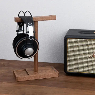 Sleek black walnut headphone stand for desktops.
